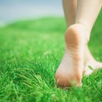 Woman legs on green grass